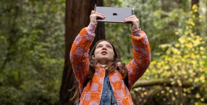 Teenager with iPad in the forrest